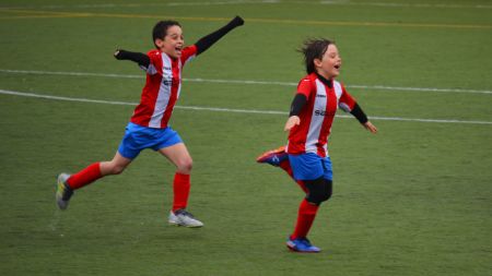 Dos niños celebrando un gol. 
